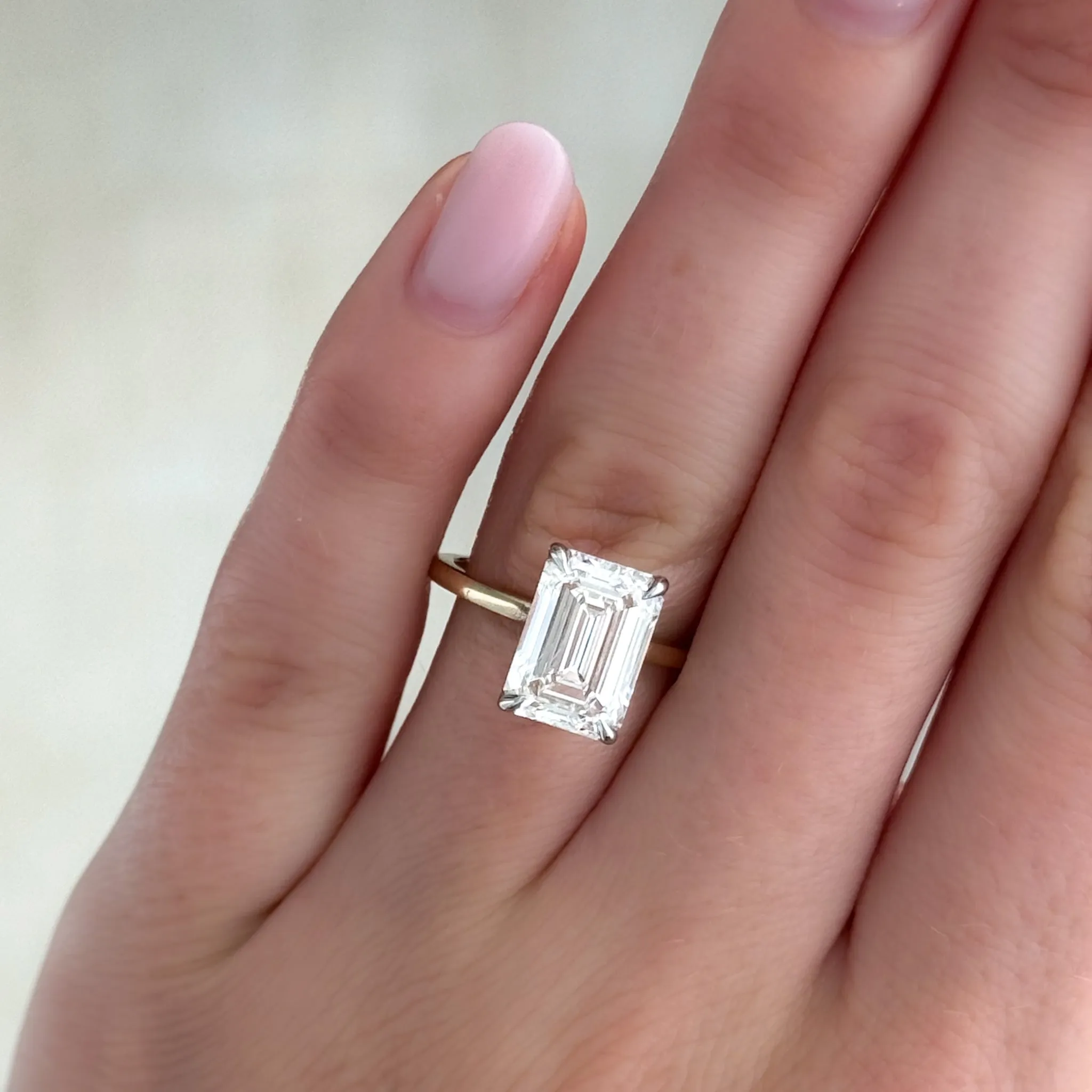 Thin   Simple Solitaire Engagement Ring With North South Emerald Cut Diamond